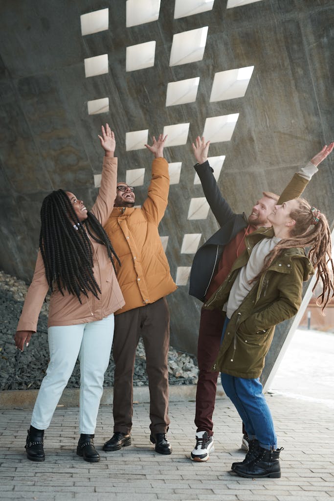 Photo of People Raising Their Hands Up